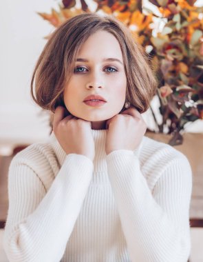 Beyaz boğazlı poz güzel genç kadın.