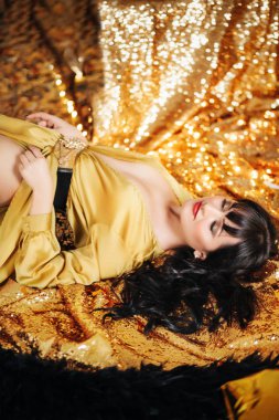 Altın elbiseyle poz güzel genç kadın