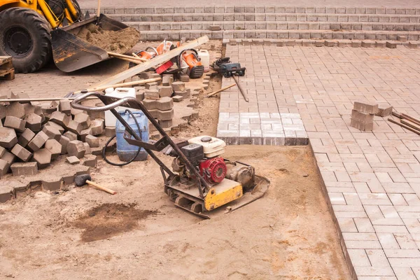 repair of the sidewalk installation of new tiles on the prepared surface improvement of the urban environment