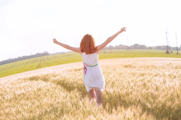 幸せな夏と自由 美しい少女の日当たりの良い 上の麦畑で実行 — ストック写真