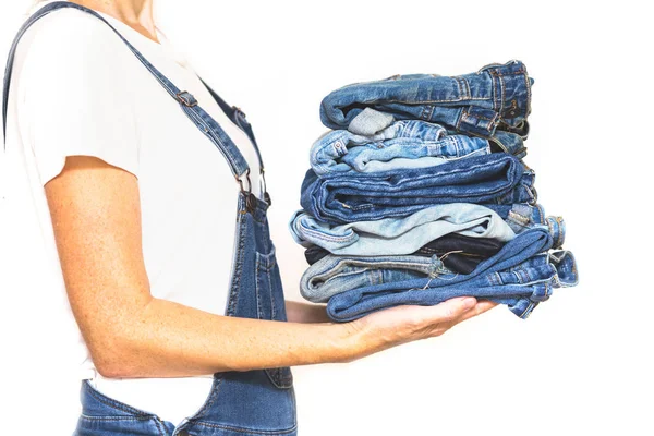 Girl Holds Stack Jeans Her Hands Cleaning Closet — Stock Photo, Image