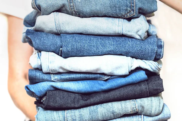 Girl Holds Stack Jeans Her Hands Cleaning Closet — Stock Photo, Image