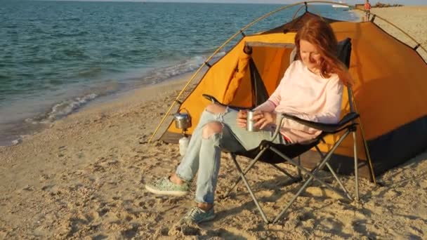 Menina Relaxante Uma Cadeira Uma Praia Areia Perto Tenda Caminhadas — Vídeo de Stock