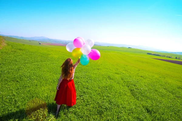 Счастливая Девушка Лугах Тосканы Красочными Воздушными Шарами Против Голубого Неба — стоковое фото