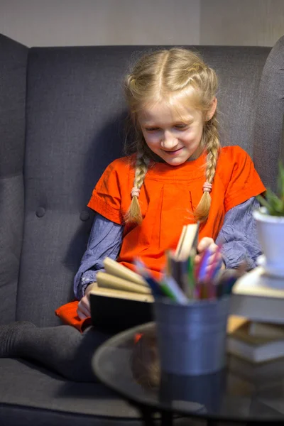 Niña Está Sentada Una Silla Está Leyendo Boo — Foto de Stock