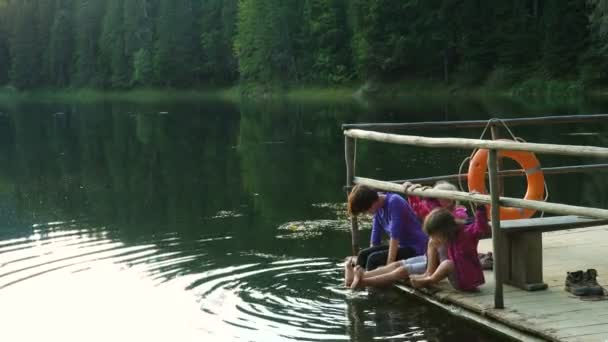 Children Sitting Lake Shore Feet Water — Stock Video