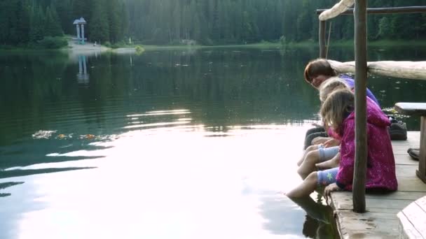 Children Sitting Lake Shore Feet Water — Stock Video