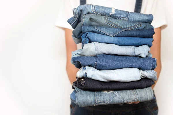 Girl Holds Stack Jeans Her Hands Cleaning Closet — Stock Photo, Image