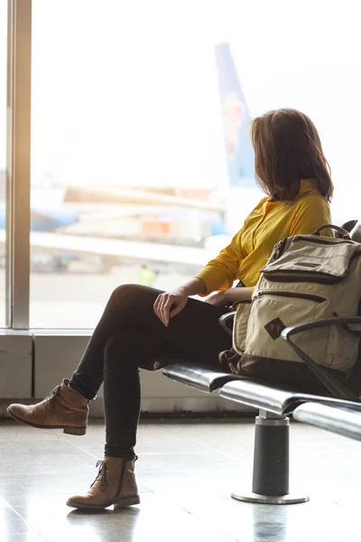 空港で出発を待っているバックパックを持つ少女 — ストック写真