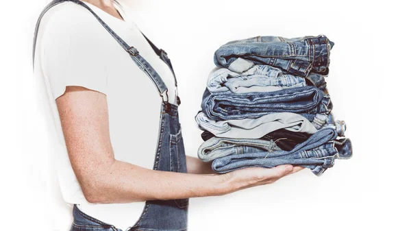 Jeans in her hands — Stock Photo, Image