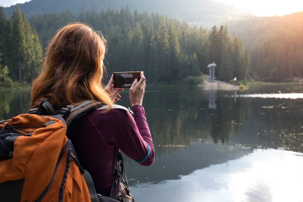 Chica turística en un lago de montaña — Foto de Stock