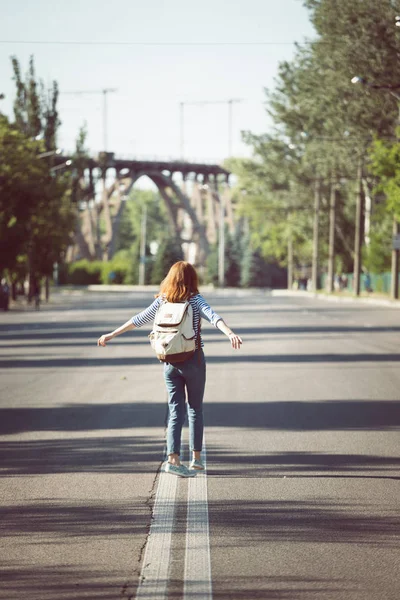 Dívka jede po prázdné silnici — Stock fotografie