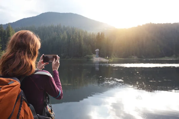 Chica turística en un lago de montaña —  Fotos de Stock
