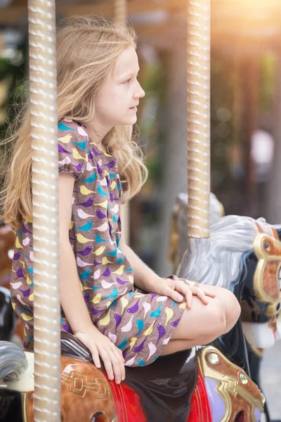 Little girl on the french carousel — Stock Photo, Image