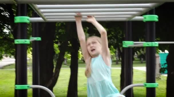 Child girl having fun on a monkey bars at the playground — Stock Footage Child Girl Having Fun Monkey Bars Playground Royalty Free Stock Footage