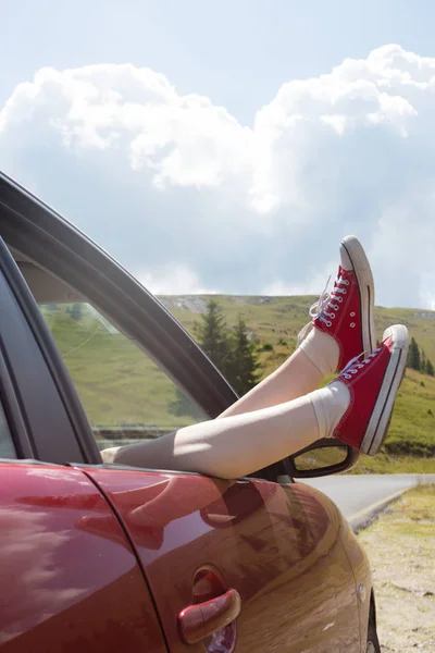 Mädchenbeine ragen aus dem Auto — Stockfoto
