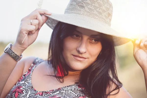 Beautiful girl in a meadow at sunset — Stock Photo, Image