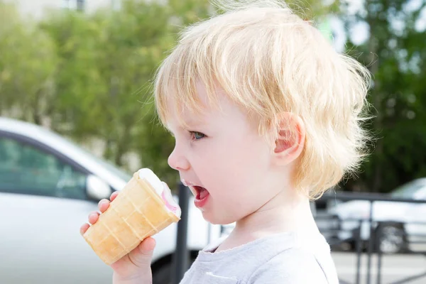 Little girl eating ice cream on the street