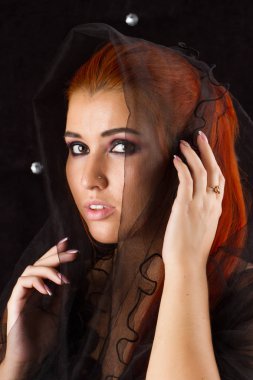 Siyah bir örtü ile Kızıl saçlı kız