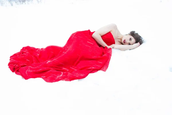 Νεαρό Κορίτσι Ένα Κόκκινο Φόρεμα Βράδυ Στο Χιόνι Πέφτει Χιόνι — Φωτογραφία Αρχείου