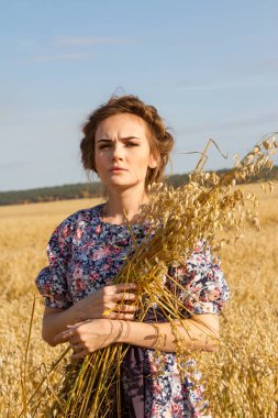 kız ellerinde kulakları ile bir alanda duruyor