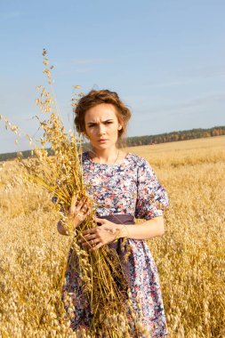 kız ellerinde kulakları ile bir alanda duruyor