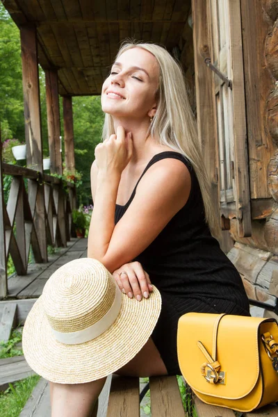 Young Blonde Black Short Dress Sits Bench Old Log House — Stock Photo, Image