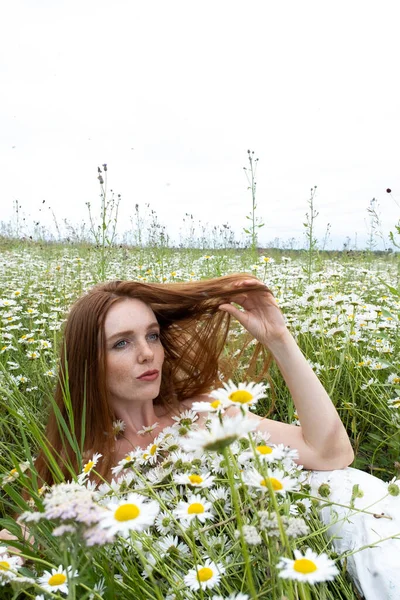 Ung Rödhårig Flicka Ett Fält Bland Kamomillblommor — Stockfoto