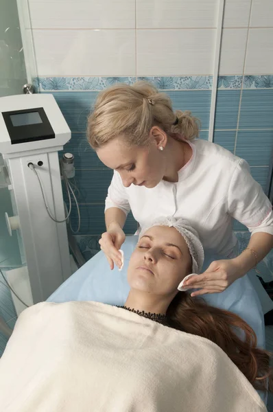 Kozmetik. Bir genç kızın yüz temizliğinde güzellik uzmanı.