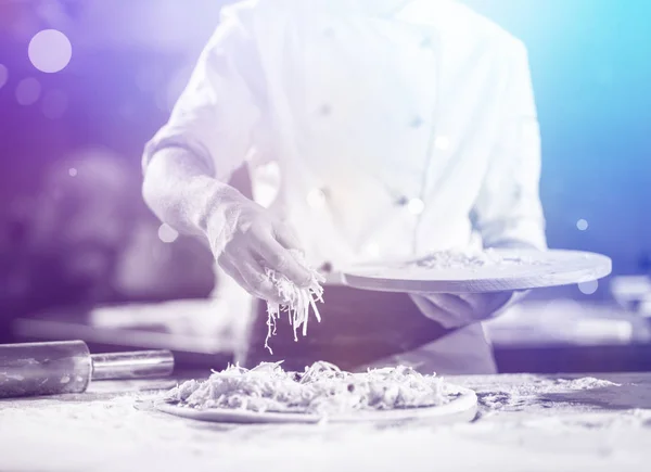 Chef Sprinkling Cheese Fresh Pizza Dough Kitchen Table — Stock Photo, Image