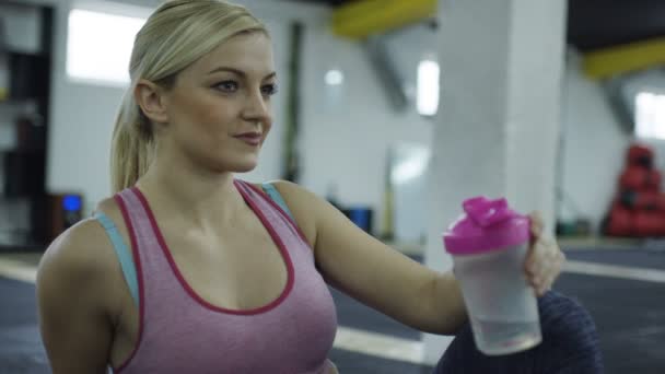 健身房硬锻炼后的妇女饮水 — 图库视频影像