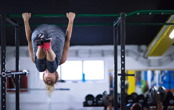 Athlete Woman Doing Abs Exercises Hanging Upside Horizontal Bar Cross Stock Photo .shock 201692576