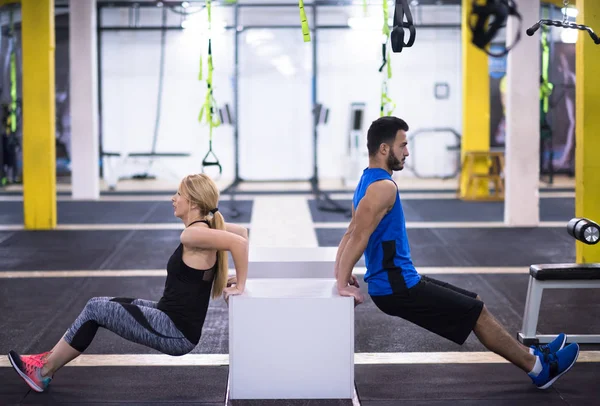 年轻夫妇在交叉健身馆用箱子锻炼手臂 — 图库照片