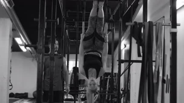 在交叉健身馆与私人教练一起练体操圈的年轻女运动员 — 图库视频影像