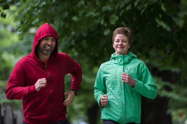 シティパークでランニングする健康なジョギングカップル 朝のトレーニングのランナーチーム — ストック写真