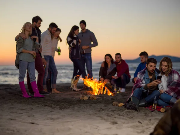 Couple Using Cell Phone Beach Party Friends Drinking Beer Having — Stock Photo, Image