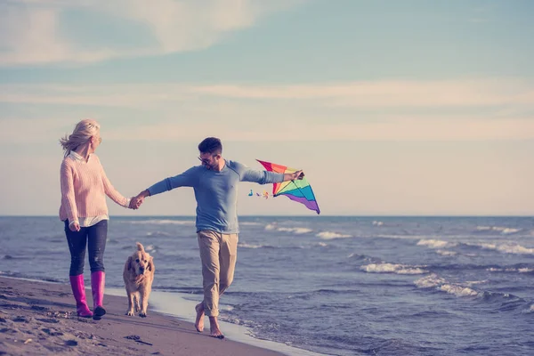 Pareja Joven Divirtiéndose Jugando Con Perro Cometa Playa Día Otoño — Foto de Stock