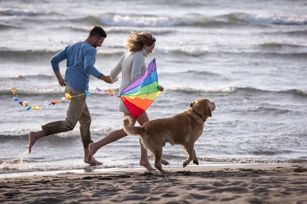 Genç Çift Eğlenmek Bir Köpek Sonbahar Günü Plaj Uçurtma Ile — Stok fotoğraf