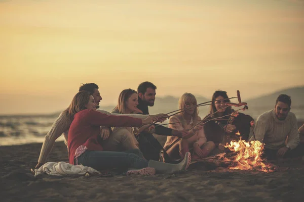 Gruppe Junger Freunde Sitzt Lagerfeuer Herbststrand Grillt Würstchen Und Trinkt — Stockfoto