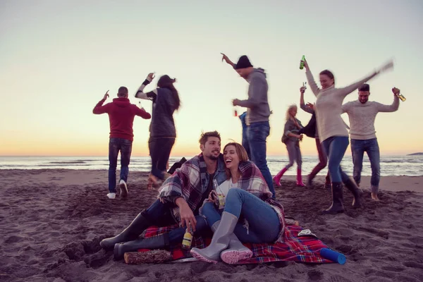 Giovane Coppia Godendo Con Gli Amici Intorno Fuoco Sulla Spiaggia — Foto Stock