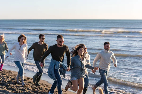 Bir Grup Genç Arkadaş Güz Günü Boyunca Kumsalda Birlikte Koşuyorlar — Stok fotoğraf