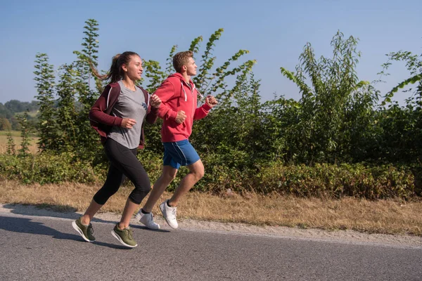 Young Couple Enjoying Healthy Lifestyle While Jogging Country Road — Stock Photo, Image