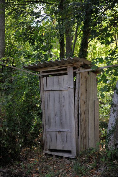 old wooden retro outdoor toilet in forest