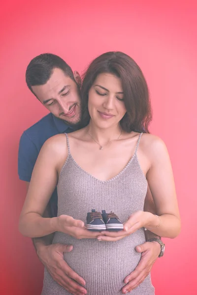 Young Pregnant Couple Holding Newborn Baby Shoes — Stock Photo, Image