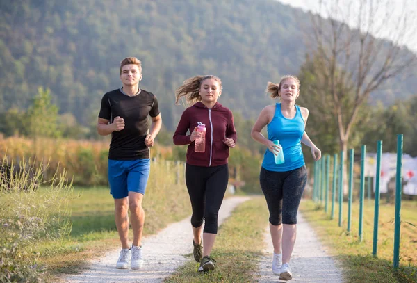 Group Young People Jogging Country Road Runners Running Open Road — Stock Photo, Image