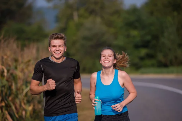 Pareja Joven Disfrutando Estilo Vida Saludable Mientras Trota Largo Camino —  Fotos de Stock