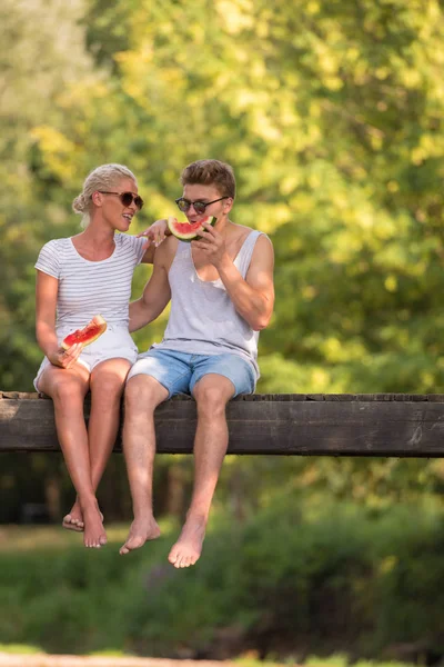 Couple Love Enjoying Watermelon While Sitting Wooden Bridge River Beautiful — Stock Photo, Image