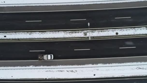vue aérienne du dessus de l'autoroute avec un faible trafic le jour d'hiver enneigé  