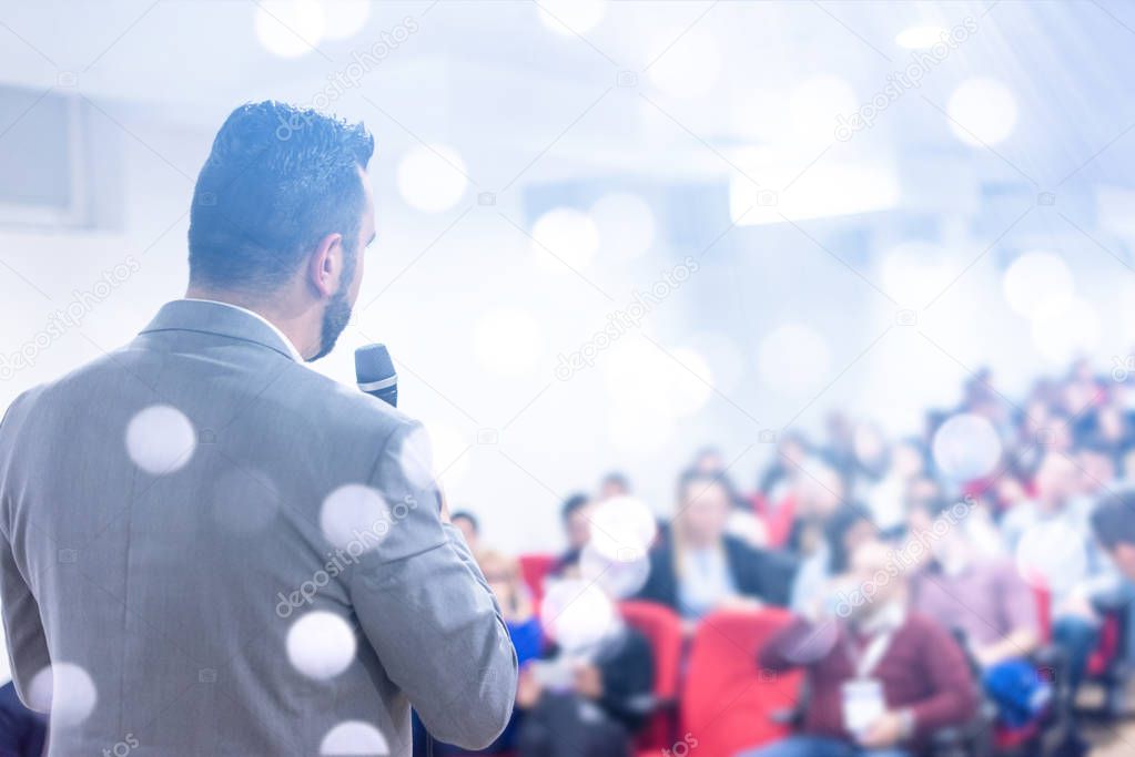 young businessman at business conference room with public giving presentations. Audience at the conference hall. Entrepreneurship club