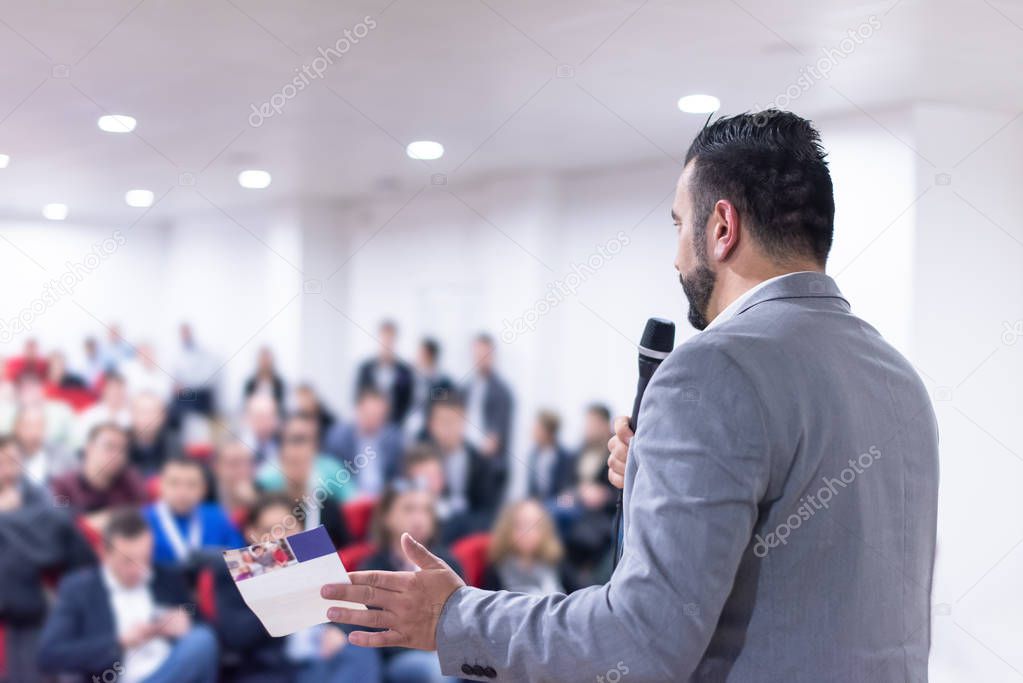 young businessman at business conference room with public giving presentations. Audience at the conference hall. Entrepreneurship club